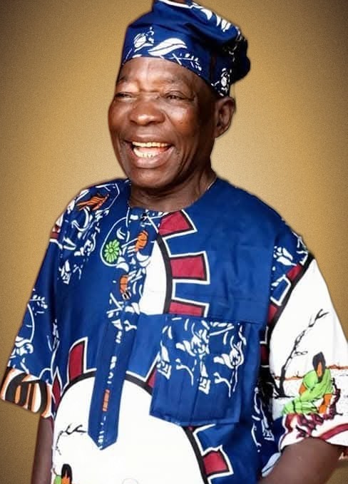 Late Pa. Hyacinth Nwafor Ogunor, smiling, in traditional blue attire